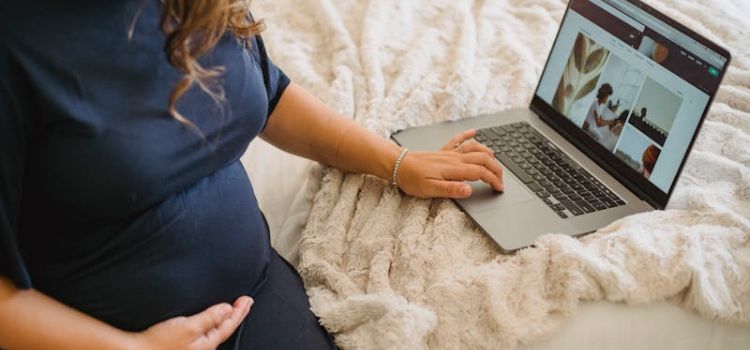 Pregnant woman researching Botox and cosmetic treatments online, seeking advice on when to stop before pregnancy